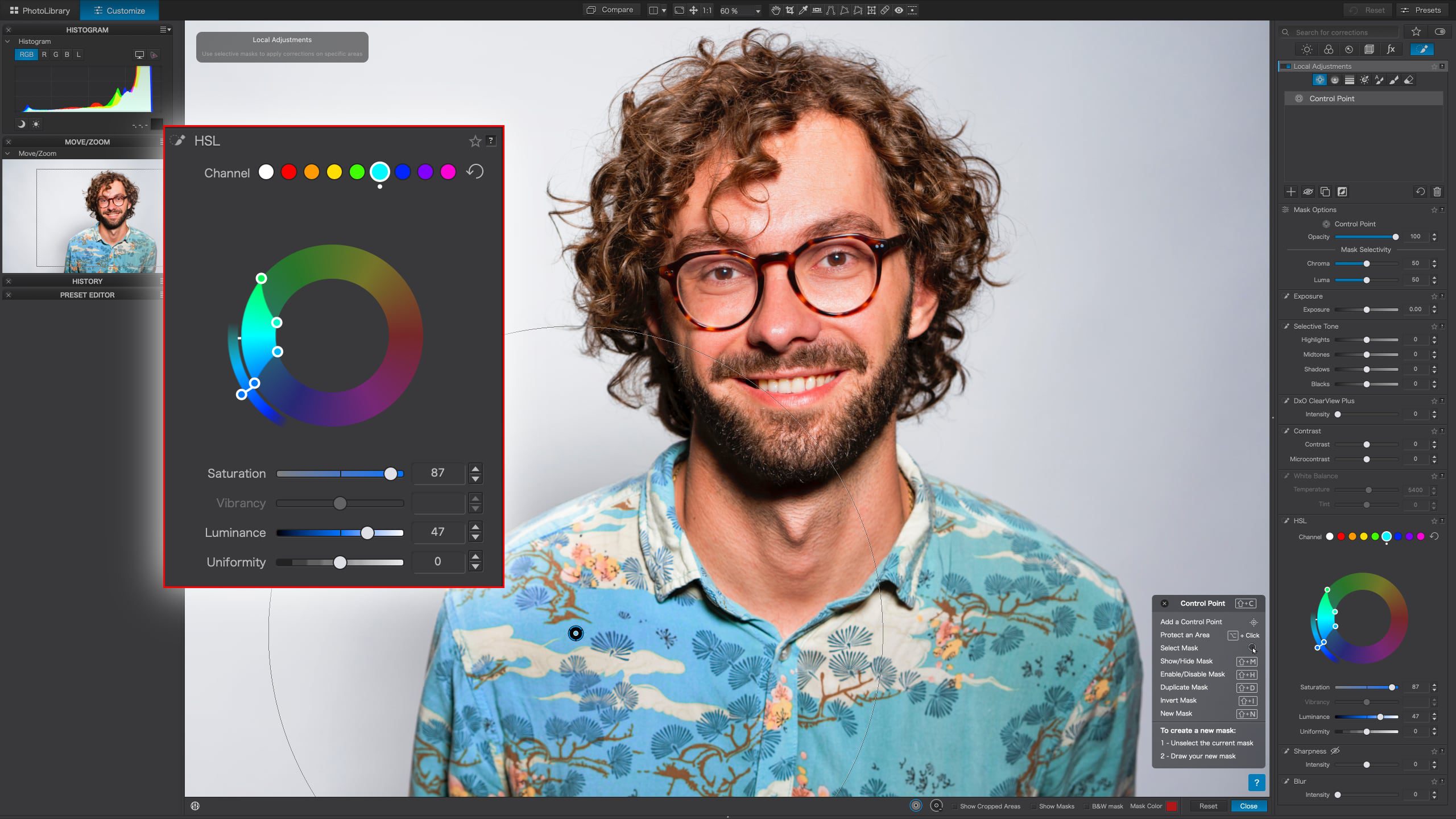 A man with glasses and a blue shirt is seen using DxO PhotoLab 7 in the photo editor.